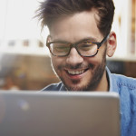 Man working on a laptop in a coffee shop